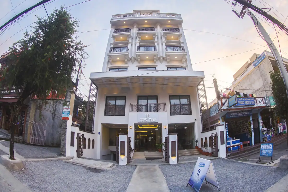 Neoclassical white facade of Hotel Fewa Trip at dusk